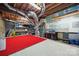 Unfinished basement with exposed ductwork, block wall, and red rug, offering potential for customization at 2004 Marquesas Ave, Tega Cay, SC 29708