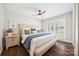Bright bedroom with a large window, plantation shutters, hardwood floors, and a king bed with stylish linens at 2004 Marquesas Ave, Tega Cay, SC 29708