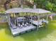 A covered boat dock on the water with lounge seating and a boat lift; features an American flag at 2004 Marquesas Ave, Tega Cay, SC 29708
