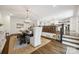 Open dining area with a chandelier, table, and views into the adjacent modern kitchen at 2004 Marquesas Ave, Tega Cay, SC 29708