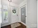 Charming entryway features glass-paneled doors, wood flooring, and white-painted trim at 2004 Marquesas Ave, Tega Cay, SC 29708