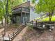 Back of house showing multiple decks and stairs leading down to lake and lakeside activities at 2004 Marquesas Ave, Tega Cay, SC 29708