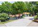 View of a Two-story home featuring a sloped driveway and mature trees, providing a private setting at 2004 Marquesas Ave, Tega Cay, SC 29708