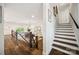 View of the home's foyer and staircase featuring hardwood floors and neutral-colored walls at 2004 Marquesas Ave, Tega Cay, SC 29708