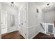 Hallway featuring hardwood floors, white walls, and access to a bathroom and stairway at 2004 Marquesas Ave, Tega Cay, SC 29708