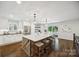 Bright kitchen featuring a large center island with seating, white cabinets, and modern lighting at 2004 Marquesas Ave, Tega Cay, SC 29708