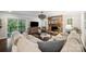 Comfortable living room with stone fireplace, large sectional sofa, and sliding glass doors to a deck at 2004 Marquesas Ave, Tega Cay, SC 29708