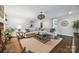Spacious living room with a large sectional sofa, hardwood floors, and access to other rooms at 2004 Marquesas Ave, Tega Cay, SC 29708