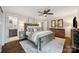 Bright main bedroom featuring a ceiling fan, hardwood floors, and ensuite bathroom access at 2004 Marquesas Ave, Tega Cay, SC 29708