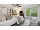 Inviting main bedroom with hardwood floors, ceiling fan, and balcony access with scenic views at 2004 Marquesas Ave, Tega Cay, SC 29708