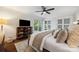Relaxing main bedroom with a ceiling fan, hardwood floors, and sliding doors to a private balcony at 2004 Marquesas Ave, Tega Cay, SC 29708