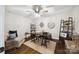 Well lit office space with a large desk, sofa, ceiling fan, hardwood floors, and rustic decor at 2004 Marquesas Ave, Tega Cay, SC 29708