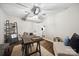 Home office features ceiling fan, hardwood floors, neutral decor, and adjacent living area view at 2004 Marquesas Ave, Tega Cay, SC 29708
