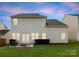 Spacious backyard with lush green grass, a patio seating area, and ample space for outdoor activities and entertaining at 204 Fesperman Cir, Troutman, NC 28166