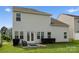 Backyard featuring well-maintained lawn, seating area, and an attractive exterior view, enhancing the home's outdoor appeal at 204 Fesperman Cir, Troutman, NC 28166