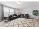Cozy bedroom features two gray sofas, a patterned rug, and natural light streaming through multiple windows at 204 Fesperman Cir, Troutman, NC 28166
