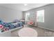Bright bedroom featuring a colorful bed, a cozy chair, and cheerful decor, perfect for a  at 204 Fesperman Cir, Troutman, NC 28166