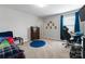 Spacious bedroom featuring a comfortable bed, modern furnishings, and a blue round rug on carpeted floors at 204 Fesperman Cir, Troutman, NC 28166