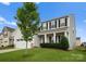 Inviting two-story home with black shutters, columns, and a lush green lawn at 204 Fesperman Cir, Troutman, NC 28166