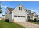 Side view of a two-story home featuring an attached two-car garage and a well-kept lawn at 204 Fesperman Cir, Troutman, NC 28166