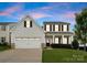 Charming two-story home with a well-manicured lawn and attached two-car garage at 204 Fesperman Cir, Troutman, NC 28166
