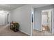 Bright hallway leading to a bathroom, showcasing clean lines, neutral colors, and a decorative shelf for added charm at 204 Fesperman Cir, Troutman, NC 28166