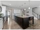 Open kitchen featuring a granite island, stainless steel appliances, and wood flooring at 204 Fesperman Cir, Troutman, NC 28166