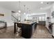 Open-concept kitchen with a large island, stainless steel appliances, and an adjacent living space at 204 Fesperman Cir, Troutman, NC 28166