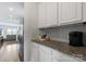 Kitchen featuring white cabinets, granite countertops, stainless steel appliances, and wood floors at 204 Fesperman Cir, Troutman, NC 28166