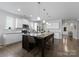 Bright kitchen with white cabinets, stainless steel appliances, and a large central island at 204 Fesperman Cir, Troutman, NC 28166