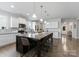 Well-lit kitchen showcasing white cabinets, a large island with seating, and modern appliances at 204 Fesperman Cir, Troutman, NC 28166
