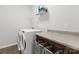 Functional laundry room featuring a modern washer and dryer set, ample counter space, and storage solutions at 204 Fesperman Cir, Troutman, NC 28166