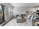 Open living room features a large gray sectional, neutral color palette, and abundant natural light from windows at 204 Fesperman Cir, Troutman, NC 28166