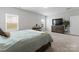 Spacious main bedroom with a bed, dresser, vanity and multiple windows allowing natural light into the space at 204 Fesperman Cir, Troutman, NC 28166