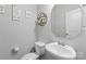 Elegant powder room featuring a modern sink, sleek fixtures, and decorative wall art, creating a sophisticated space at 204 Fesperman Cir, Troutman, NC 28166