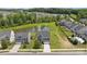 Aerial view of the home with its well-maintained lawn and the tranquil pond nearby at 207 Welcombe St, Mooresville, NC 28115