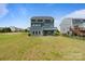 Large backyard with a well-maintained lawn and a small deck, perfect for outdoor activities at 207 Welcombe St, Mooresville, NC 28115