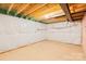 Unfinished basement with exposed beams and vapor barrier at 207 Welcombe St, Mooresville, NC 28115