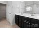 Bathroom featuring a double sink vanity with dark wood cabinets and a large mirror at 207 Welcombe St, Mooresville, NC 28115