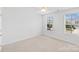 Bright bedroom with two windows and neutral carpet at 207 Welcombe St, Mooresville, NC 28115
