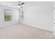 Bright bedroom featuring a ceiling fan, carpet, and ample natural light at 207 Welcombe St, Mooresville, NC 28115