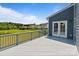 Back deck overlooking a pond and green space, with a view of nearby houses at 207 Welcombe St, Mooresville, NC 28115