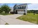 Beautiful home showcasing manicured landscaping, a wide driveway, and a welcoming two-car garage at 207 Welcombe St, Mooresville, NC 28115