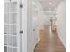 Bright hallway with hardwood floors, white trim, and a staircase leading to the upper level at 207 Welcombe St, Mooresville, NC 28115