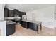 Modern kitchen featuring granite countertops, dark cabinets and a kitchen island at 207 Welcombe St, Mooresville, NC 28115