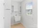 Functional laundry room with utility sink, cabinets and natural light at 207 Welcombe St, Mooresville, NC 28115