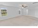Spacious main bedroom featuring neutral carpet, a ceiling fan, and bright windows at 207 Welcombe St, Mooresville, NC 28115