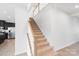 View of the carpeted staircase with white walls and wood railing leading to the second floor at 207 Welcombe St, Mooresville, NC 28115