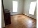 Empty bedroom featuring hardwood floors and natural light from two windows at 209 14Th Se Ave, Hickory, NC 28602
