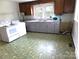 Kitchen space with a stove, vintage flooring, and ample counter space at 209 14Th Se Ave, Hickory, NC 28602